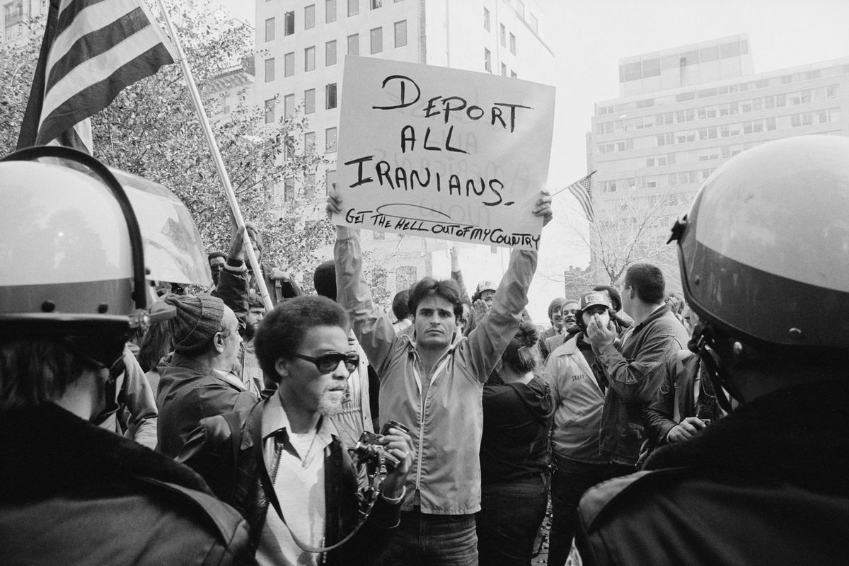 1920px-Man_holding_sign_during_Iranian_hostage_crisis_protest%2C_1979.jpg
