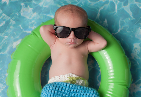 baby in sunglasses on rubber ring in pool 474.jpg