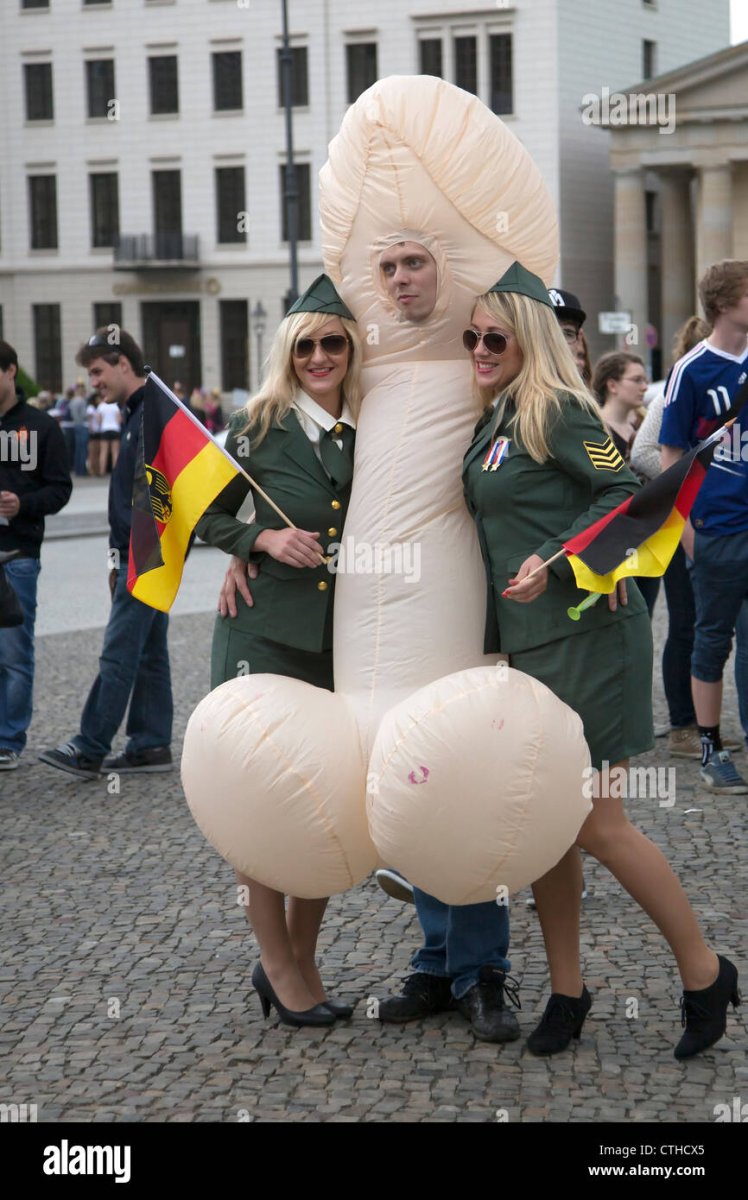 in-berlin-a-man-dressed-as-a-penis-hugs-two-blond-women-posing-as-CTHCX5.jpg